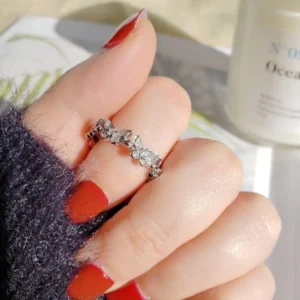 Silver adjustable ring featuring multiple sparkling butterfly designs with crystal accents, perfect for stylish everyday wear.