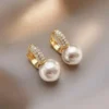 Gold-plated hoop earrings with pearl drop and crystal accents – luxury fashion jewelry.