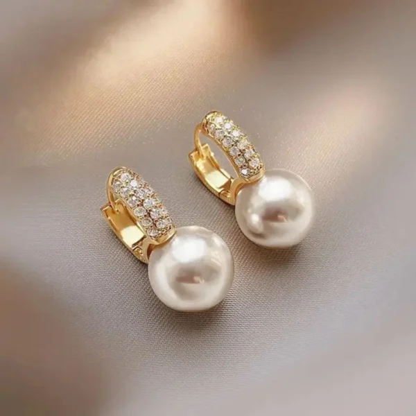 Gold-plated hoop earrings with pearl drop and crystal accents – luxury fashion jewelry.