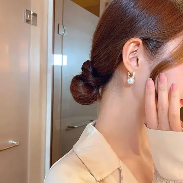 Gold-plated hoop earrings with pearl drop and crystal accents – luxury fashion jewelry.