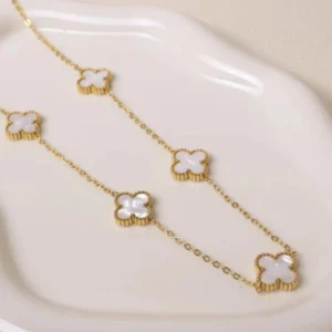 Minimal gold chain clover charm necklace with white enamel inlay – elegant daily wear jewelry.