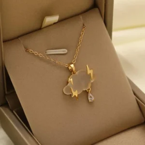 Gold chain necklace with a matte cloud pendant, gold lightning bolts, and a crystal raindrop charm.