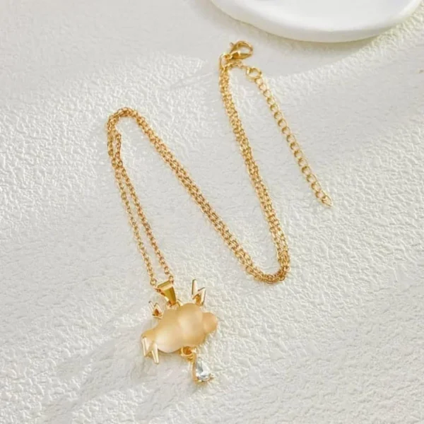Gold chain necklace with a matte cloud pendant, gold lightning bolts, and a crystal raindrop charm.
