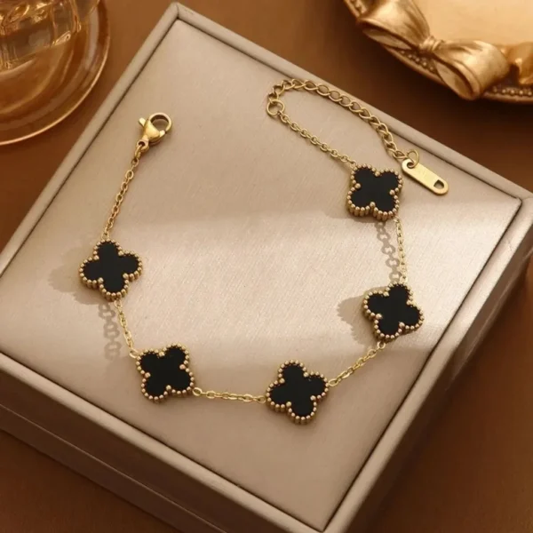 Gold-plated bracelet with black clover charms – trendy daily wear jewelry for women