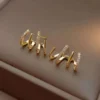Gold “uh huh” word earrings with crystal detailing – bold trendy statement studs for women