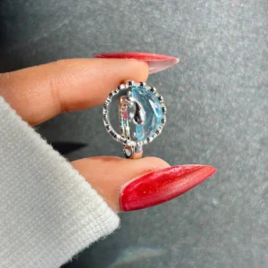 Silver-tone ring with an artistic ocean wave design and translucent blue detail, giving beachy, water-core aesthetic.