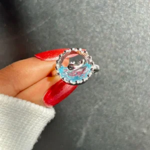 Silver-tone ring with an artistic ocean wave design and translucent blue detail, giving beachy, water-core aesthetic.