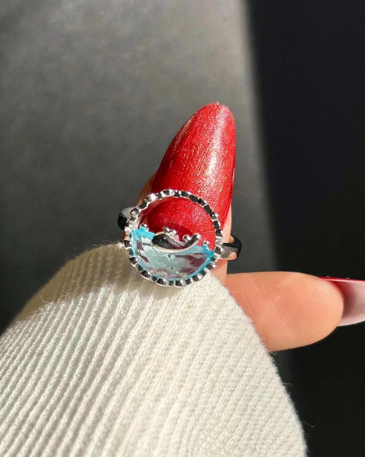 Silver-tone ring with an artistic ocean wave design and translucent blue detail, giving beachy, water-core aesthetic.