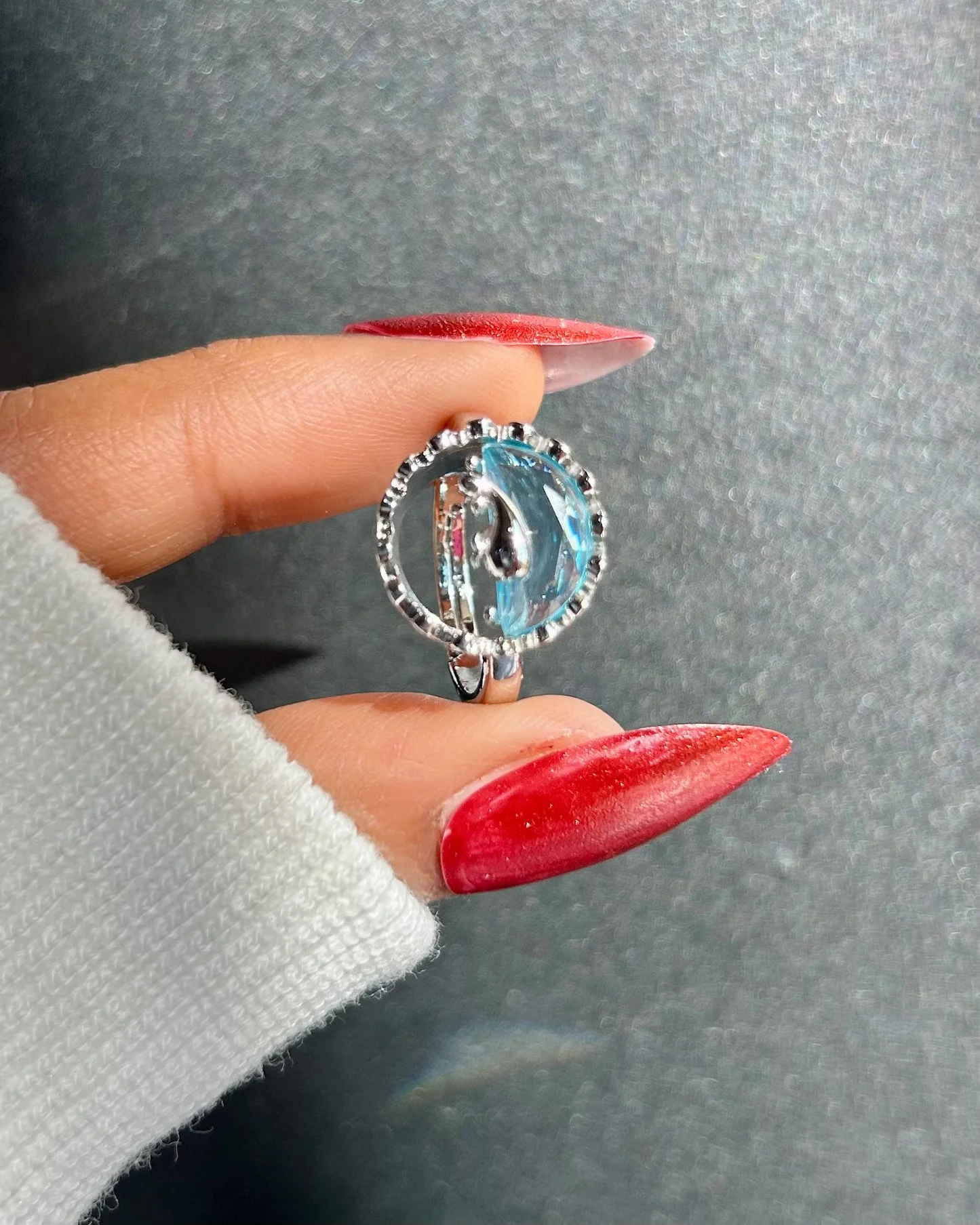 Silver-tone ring with an artistic ocean wave design and translucent blue detail, giving beachy, water-core aesthetic.