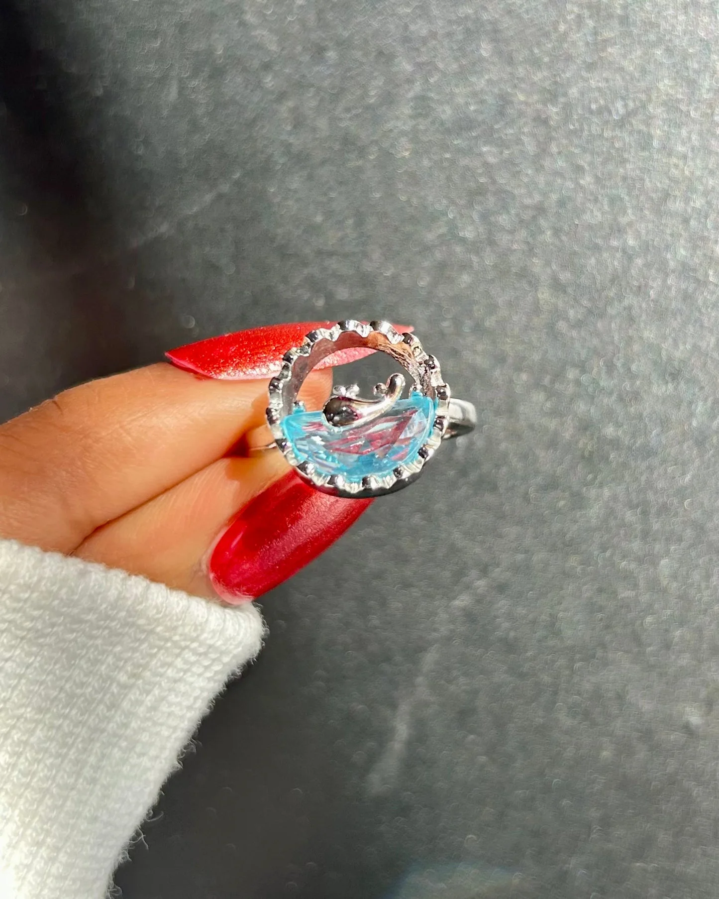 Silver-tone ring with an artistic ocean wave design and translucent blue detail, giving beachy, water-core aesthetic.