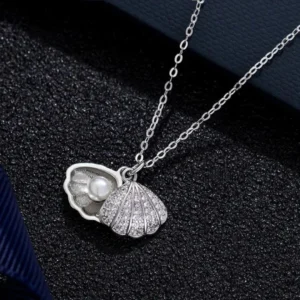 Silver seashell pendant necklace with pearl inside, elegant ocean-themed jewelry for women