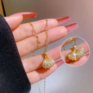 Gold seashell pendant necklace with a hidden pearl inside, ocean-themed elegant neckpiece for women