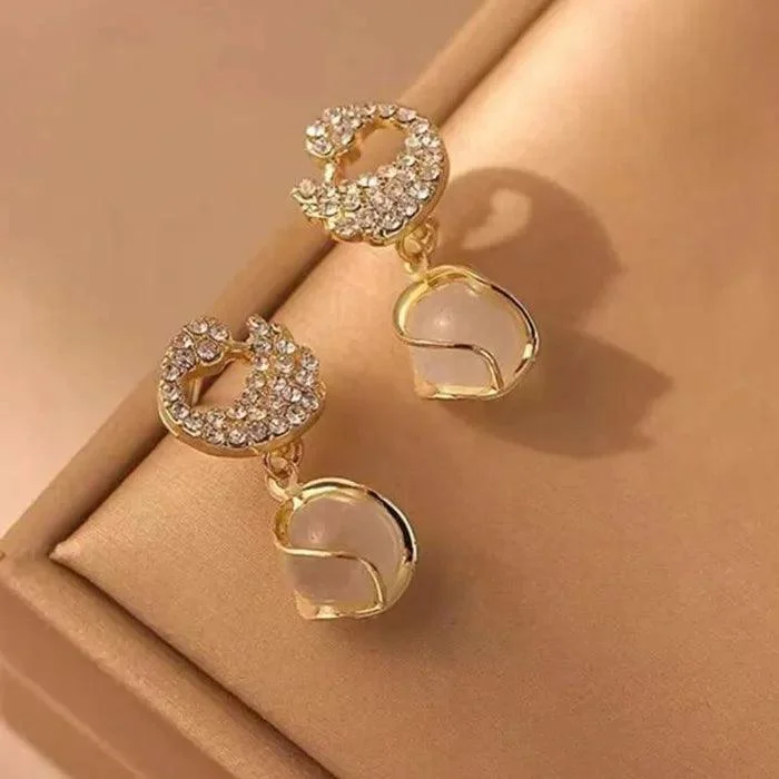 Gold earrings with crystal-studded crescent moons and opal-style dangling drops – celestial party jewelry