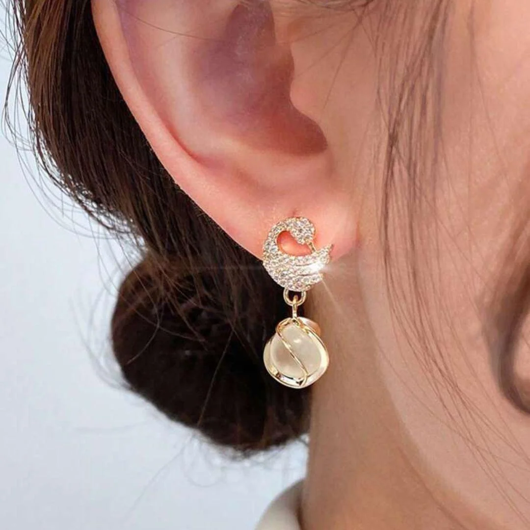 Gold earrings with crystal-studded crescent moons and opal-style dangling drops – celestial party jewelry