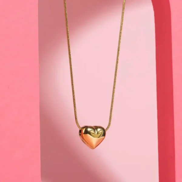 Chunky gold heart pendant necklace with snake chain – bold and minimal statement jewelry for women.