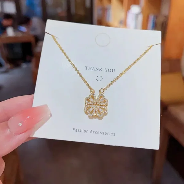 Gold-plated clover-shaped necklace with sparkling white stones and intricate floral heart design