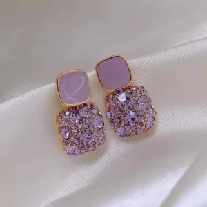 Detailed zoom of purple rhinestone earrings