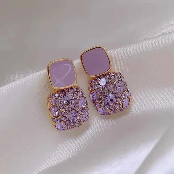 Detailed zoom of purple rhinestone earrings