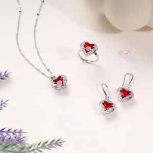 3-piece jewelry set with red heart-shaped crystals in silver setting – includes necklace, earrings, and ring.