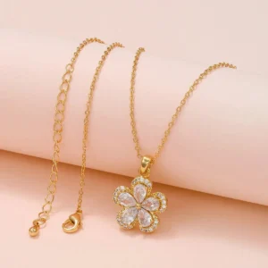 Gold chain necklace with 5-petal clover pendant covered in white crystals – elegant floral daily wear jewelry.
