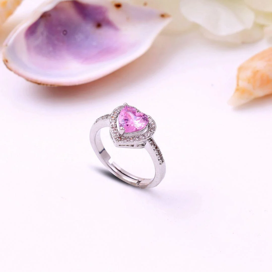 Silver ring with a pink heart-shaped center stone surrounded by micro-pave crystals, perfect for romantic, trendy everyday looks.