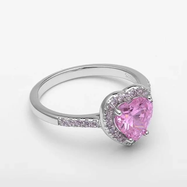 Silver ring with a pink heart-shaped center stone surrounded by micro-pave crystals, perfect for romantic, trendy everyday looks.