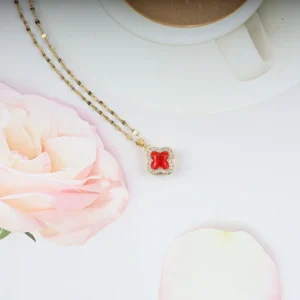 Gold plated red clover pendant necklace with crystal border – elegant, bold everyday jewelry for women.