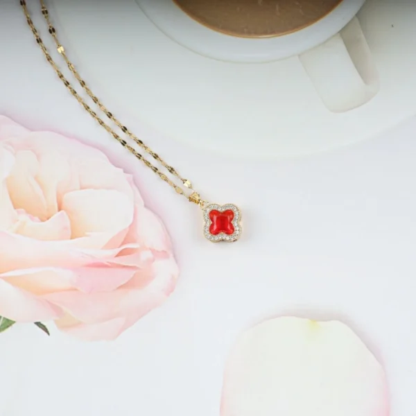 Gold plated red clover pendant necklace with crystal border – elegant, bold everyday jewelry for women.