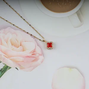 Gold plated red clover pendant necklace with crystal border – elegant, bold everyday jewelry for women.