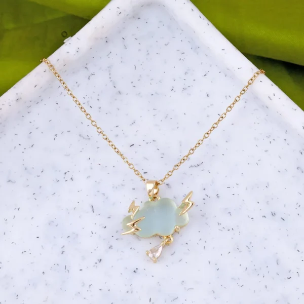 Gold-plated thundercloud pendant with lightning bolts and teardrop crystal on a light green charm.