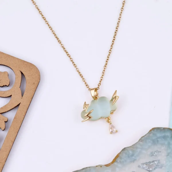 Gold-plated thundercloud pendant with lightning bolts and teardrop crystal on a light green charm.
