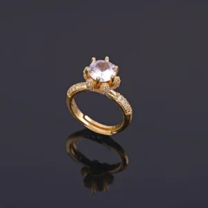 Gold plated ring with large central crystal and rhinestone-studded band, perfect for party wear or cocktail look.