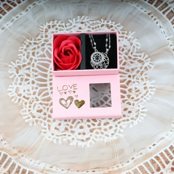 Pink “LOVE” gift box with silver moon and dreamcatcher couple pendant necklace and red rose, gold hearts and transparent window.