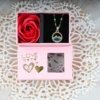 Pink βLOVEβ gift box with silver moon and dreamcatcher pendant necklace and one artificial red rose, golden hearts and transparent window.
