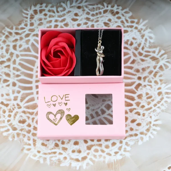 Pink “LOVE” gift box with couple-hug pendant necklace and one artificial red rose, gold heart print and display window.