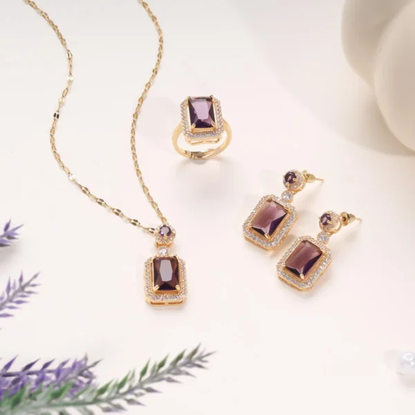 Gold plated necklace, ring, and earrings set with deep wine red emerald-cut stones and crystal border