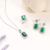 Glamorous green gemstone jewelry set with emerald-style stones in silver-tone setting, includes necklace, ring, and earrings.