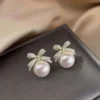 Elegant pearl stud earrings with crystal-studded gold bows – party wear jewelry for women & girls
