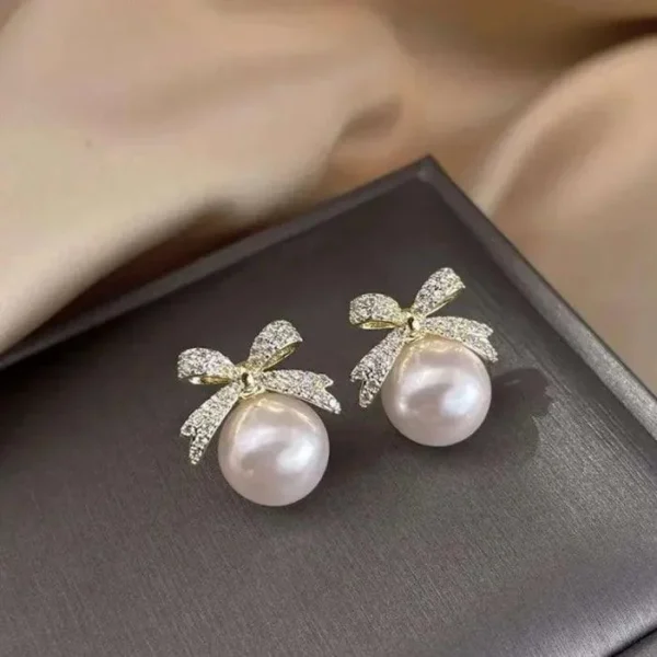 Elegant pearl stud earrings with crystal-studded gold bows – party wear jewelry for women & girls