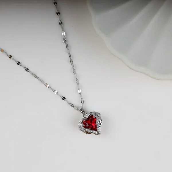 Silver chain necklace with a deep red heart-shaped crystal pendant, accented by sparkling stones – perfect for daily wear or gifting.