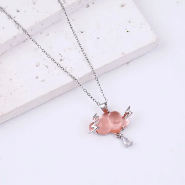 Silver-plated pink cloud pendant necklace with lightning bolts and crystal drop charm.