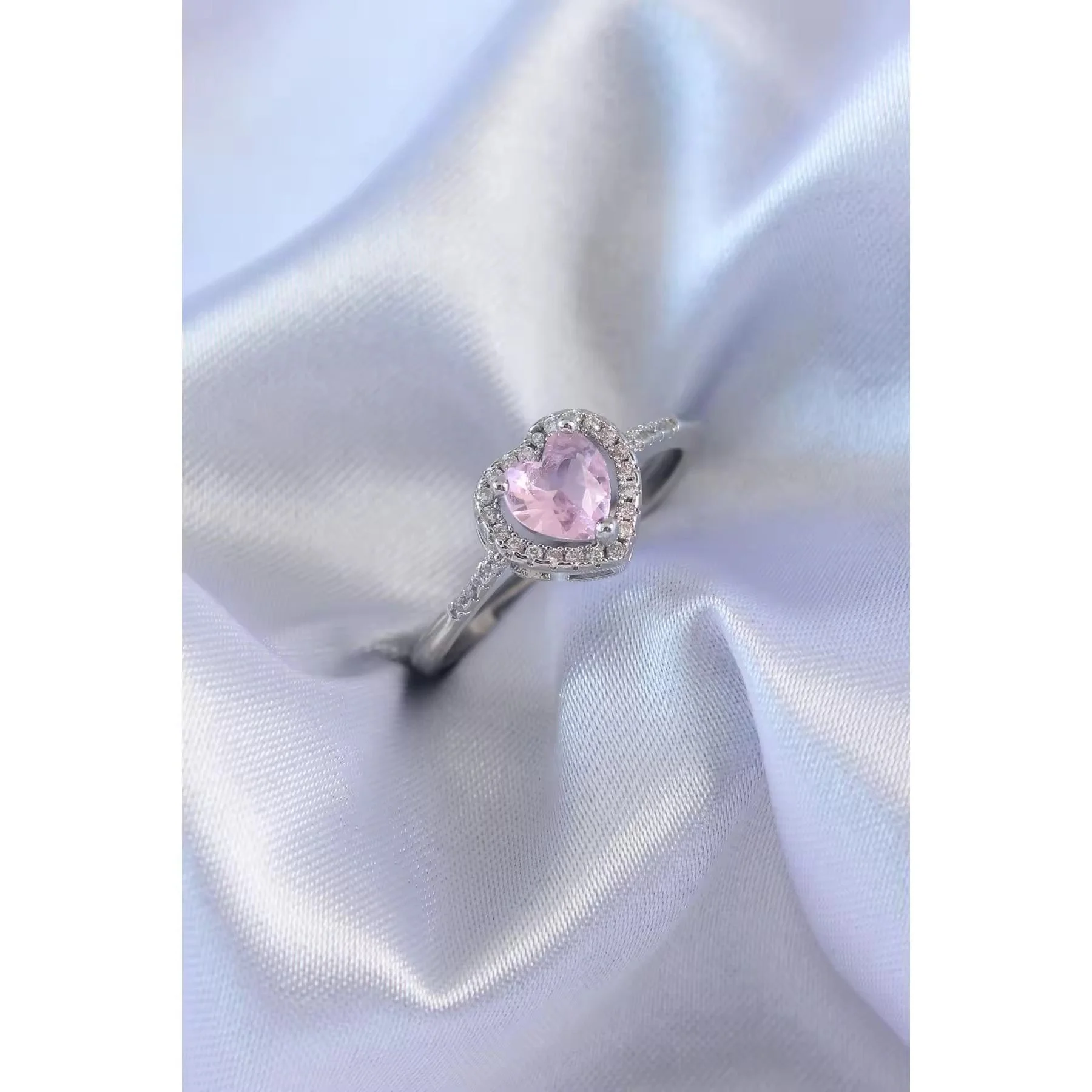 Silver ring with a pink heart-shaped center stone surrounded by micro-pave crystals, perfect for romantic, trendy everyday looks.