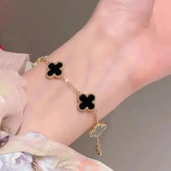 Gold-plated bracelet with black clover charms – trendy daily wear jewelry for women