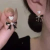 Black bow drop earrings with crystal heart studs, bold and elegant fashion jewelry for women