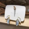 Gold leaf stud earrings with white and blue enamel, minimal daily wear jewelry for women