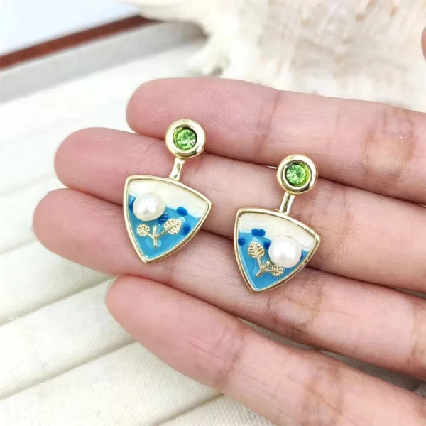 Gold-toned drop earrings with green gemstone top, blue enamel sea design and pearl accent