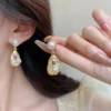 Elegant gold drop earrings with pearl top and embedded rose detail, statement party earrings for girls