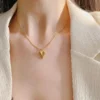 “Minimal gold heart pendant necklace on model”